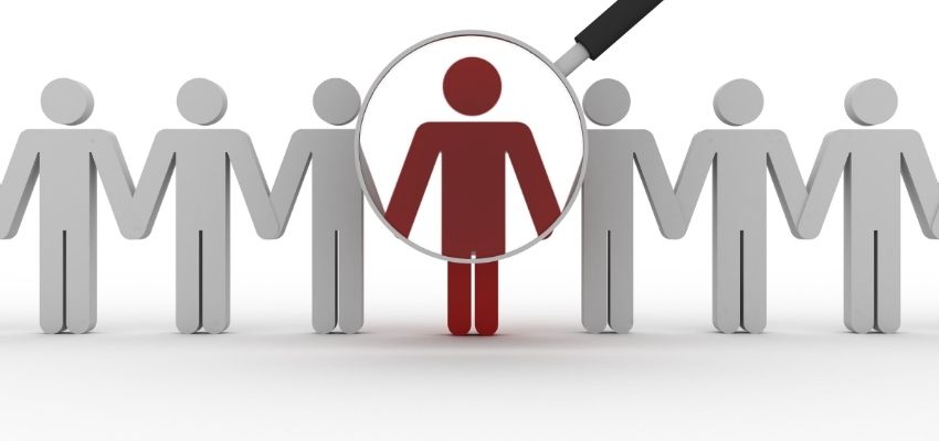lens pointing at red man figure among others