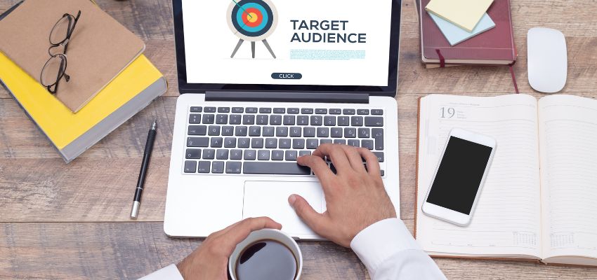 In order to successfully develop a brand, you must understand your target audience. While it may be hard to know exactly what your customers are looking for, a clear understanding of your industry, target consumers, and competitors is essential. By gaining an understanding of your market, you will be able to identify the gap in your market and position your brand accordingly. Positioning begins internally and requires research and market assessment. An open laptop with a target on screen and an hand covering the keyboard